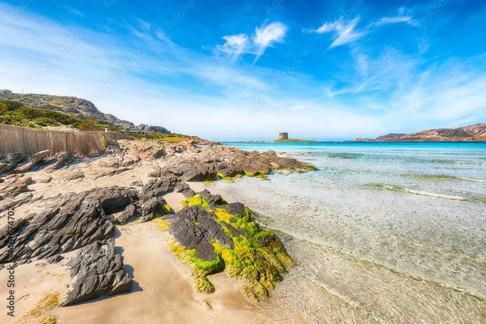 Unbelivable morning view of famous La Pelosa beach and rocky shore near Torre della Pelosa