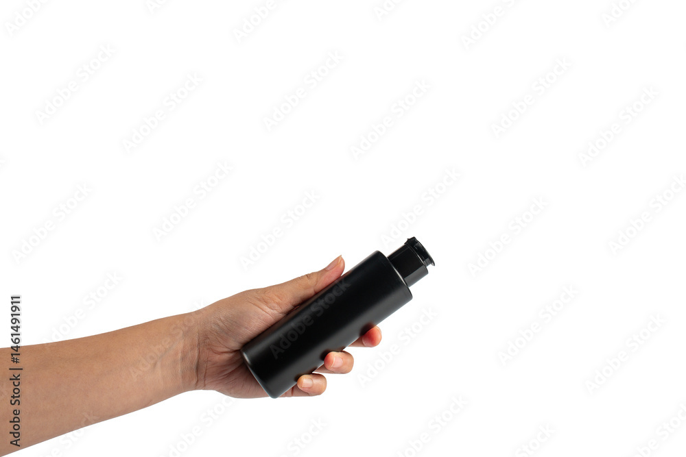 Fototapeta premium Black cosmetic flip top bottle in hand isolated on transparent background.