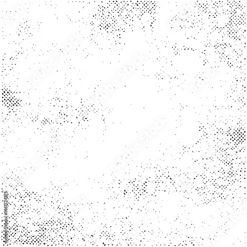 A textured white background displays a dense scattering of small dark dots across the entire frame.