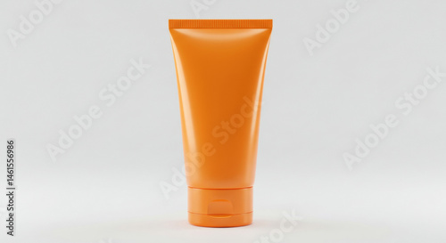 Orange tube of sunscreen product in a studio setting. Product standing upright on white background. Cosmetic product for personal care in a retail studio. Isolated product shot.