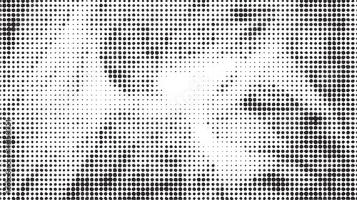 A grayscale portrait reveals a blurred human face through numerous small dots.