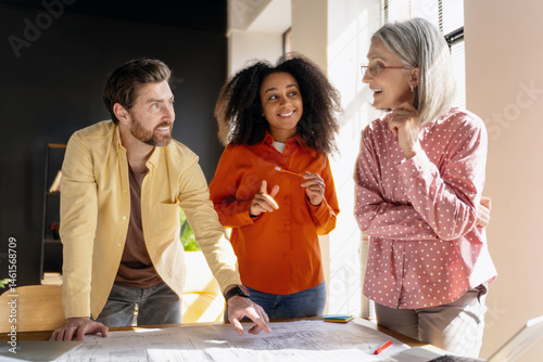 Architects discussing blueprints in the office