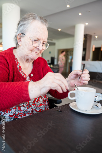 Portrait of an 86 yo grandmother drinking coffee in a wheelchair home in Tienen, Flemish Brabant, Belgium