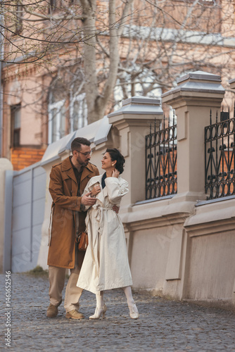 Wallpaper Mural Man and woman in vintage-style clothes walk side by side on cobblestone street, sharing gentle, romantic moment. Concept of timeless fashion, romance, connection, stylish daily life. Torontodigital.ca