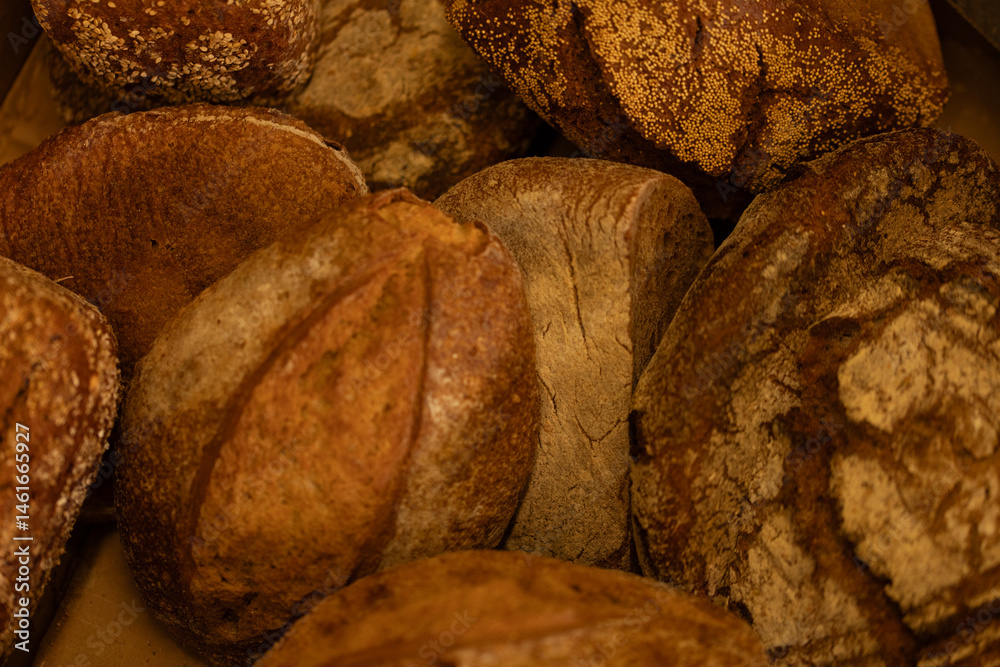 Close-up of rustic loaves, perfect for bakery websites or food blogs. High-quality image.