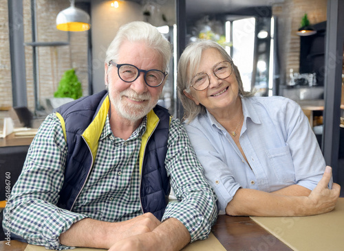 Happy senior couple enjoying time together at a café — mature love, healthy aging, relaxed lifestyle, retirement happiness, modern elderly lifestyle