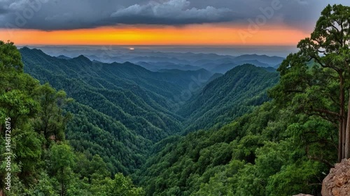 Majestic Mountain Landscape at Sunrise Overlooking Serene Green Valley and Rolling Hills in Distant Horizon