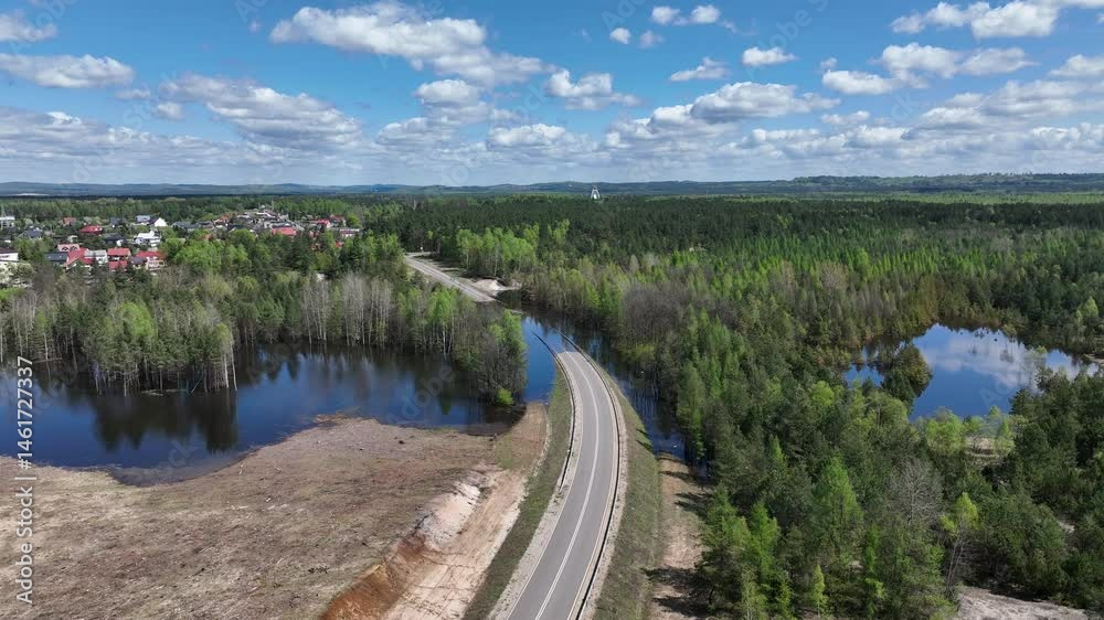 Lake District swallow hole flooded as a result of the mining damage Pomorzany mine in Olkusz,Poland. Aerial drone view of flooded road. Forest submerged in a lake. Sunken sandpit with clear water Lake District swallow hole flooded as a result of the mining damage Pomorzany mine in Olkusz,Poland. Aerial drone view of flooded road. Forest submerged in a lake. Sunken sandpit with clear water