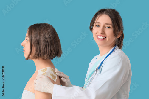 Female doctor applying must...