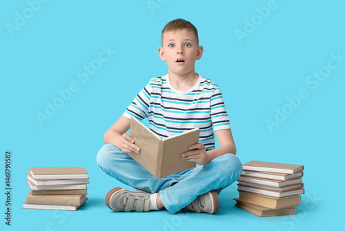 Surprised little boy with b...