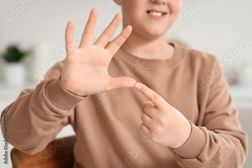 Mute boy using sign languag...