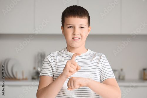 Mute boy using sign language at home photo