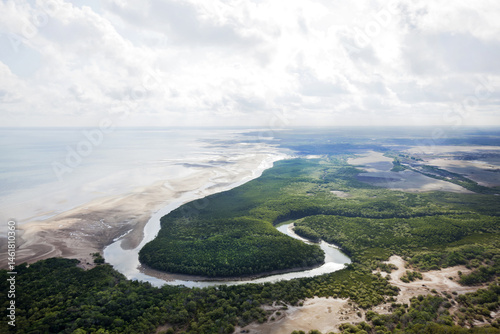 Aerial view of a curving river system running into the ocean