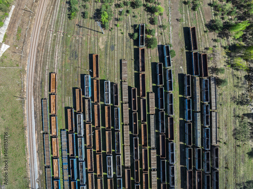 Obraz na płótnie Aerial drone photo of Cargo train terminal, railway hub. Railway wagons on the tracks in industrial area. w salonie