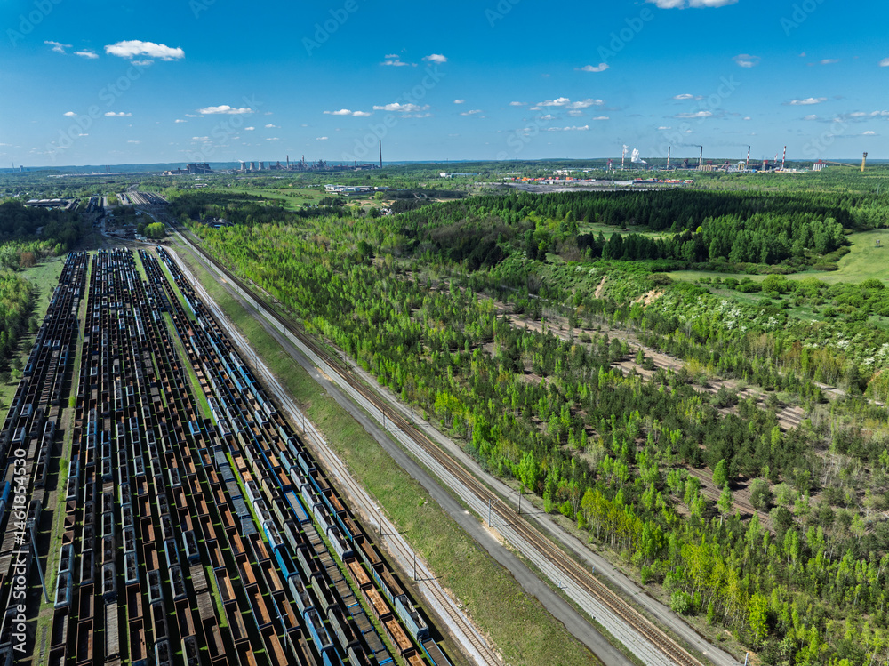 Aerial drone photo of Cargo train terminal, railway hub. Railway wagons on the tracks in industrial area.
