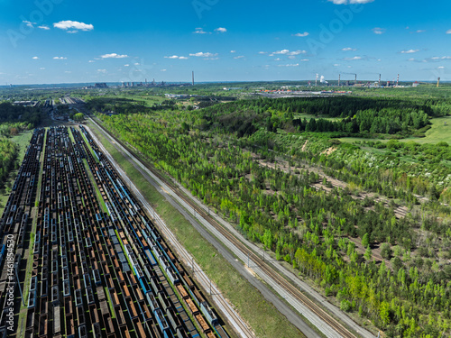 Obraz na płótnie Aerial drone photo of Cargo train terminal, railway hub. Railway wagons on the tracks in industrial area. w salonie