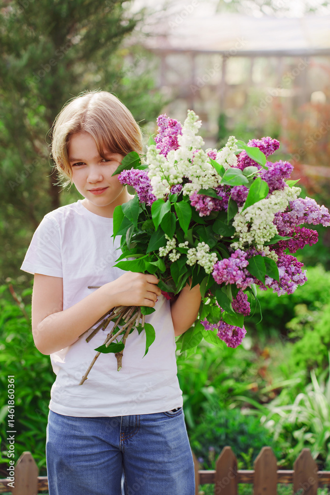 Young girl gathers lilac flowers in a vibrant garden during springtime