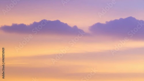 Gentle gradients of peach and violet paint the evening sky, as soft clouds float quietly in distance against an airbrushed heaven.