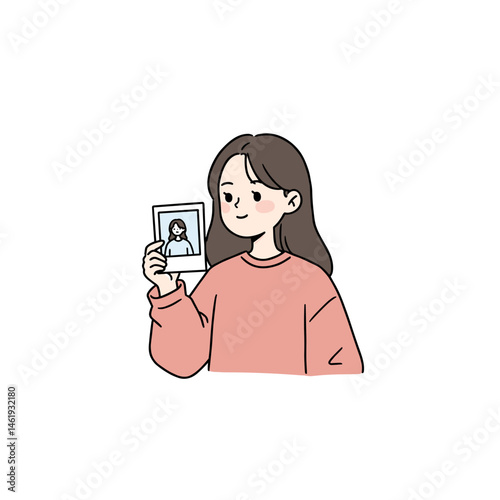 Woman holding a Polaroid photo with a nostalgic smile, wearing a pink sweater, on a white background