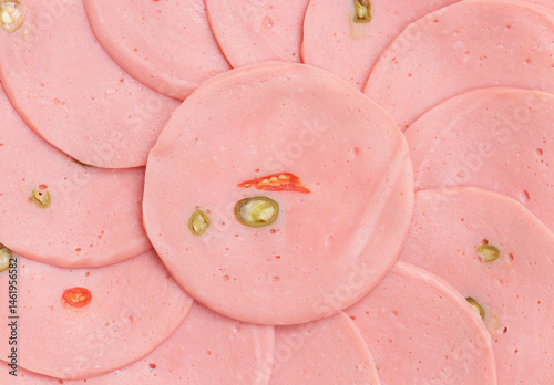 Obraz na plátně Sliced ​​bologna sausages stuffed with chili stacked in a circle