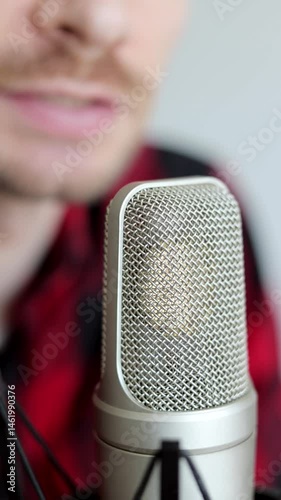 Influencer podcast creator streaming audio broadcast or recording audiobook. Broadcasting an interview using microphone. Vertical video.
