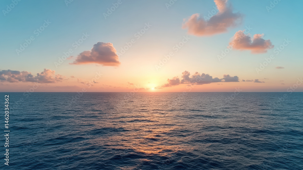 Obraz premium Serene ocean view at sunset with soft clouds and vibrant colors reflecting on water