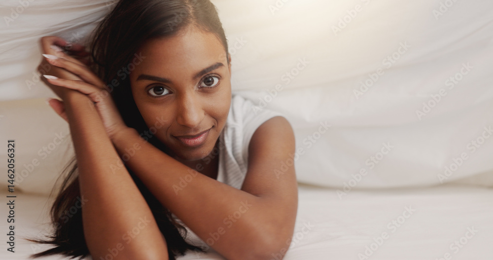Obraz premium Blanket, happy and portrait of woman in bed for morning or weekend break and relaxing. Duvet, hospitality and vacation with Indian person under covers in hotel or lodge for accommodation or holiday