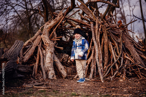 Child Playing with Stick Near Forest Fort