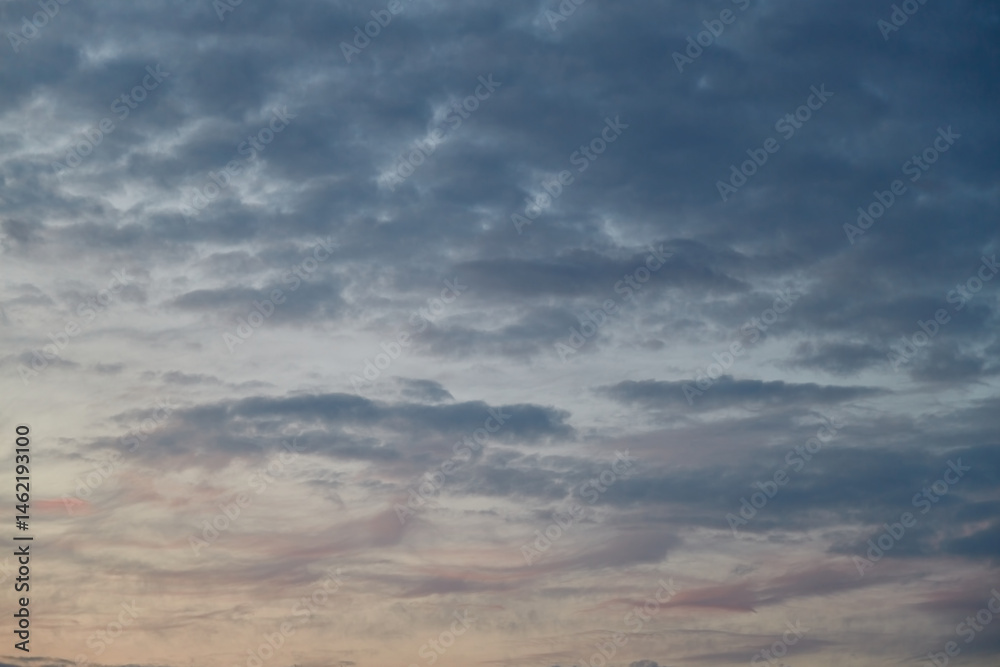 Obraz premium Pastel shades of the sky and clouds in the evening light create an atmosphere of coziness, relaxation, and romance. The photo is suitable for advertising sleep, comfort, and relaxation products.