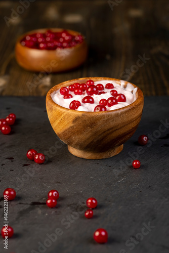 milk product made from milk with the addition of red sweet and sour currants and currant flavor, close up, side view