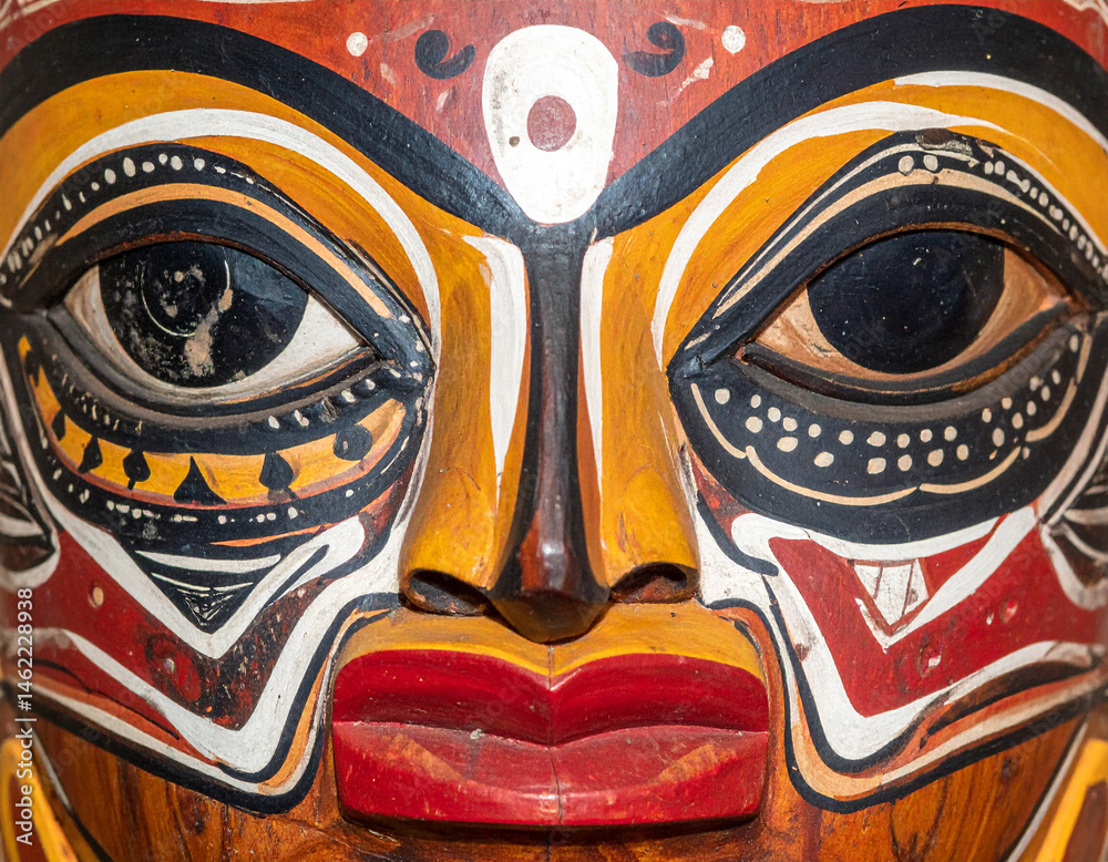 Naklejka premium The intricate patterns on a painted wooden mask used in indigenous Ecuadorian rituals.