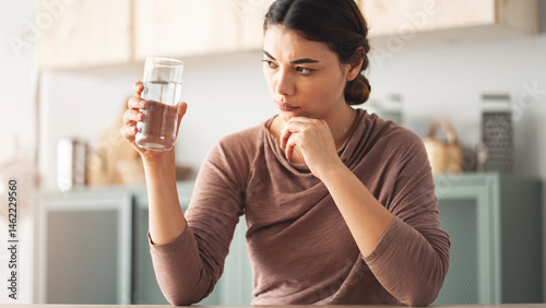 Looking at a glass of water with suspicion