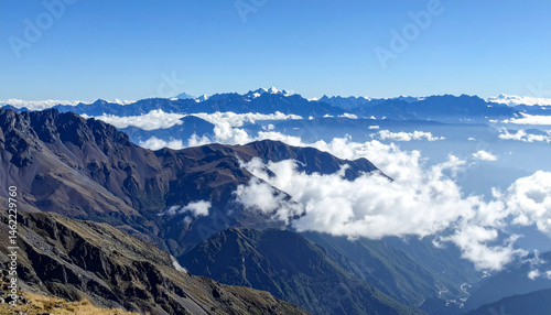 A view of the majestic Andes Mountains with layers of clouds hovering above peaks.