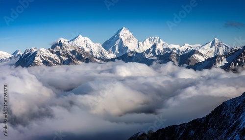 snow capped peaks rise above a sea of clouds