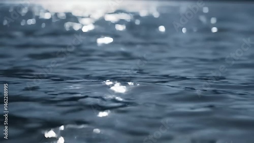 Close-up view of rippling water surface with sunlit sparkles
