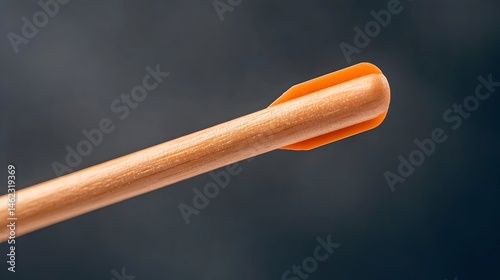 Close-up of a light-wood shaft with an orange plastic nock