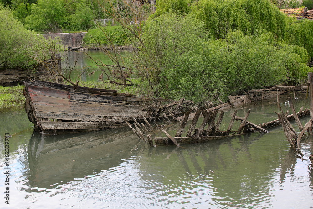 Bow of th sunken old ship called BURCIO or BURCHIO in italian language in the BURCI CEMETERY a suggestive place in the bend of the river SILE in Northern Italy with wrecks of old sunken wooden boats