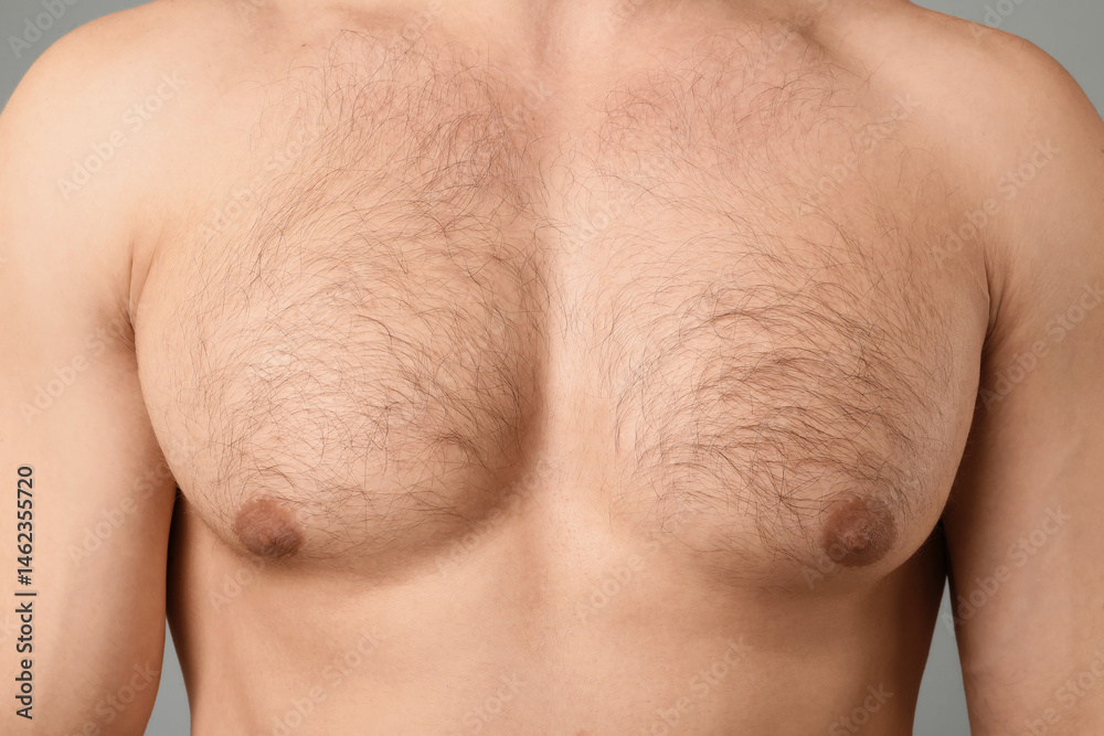 Naklejka premium Young man with hairy chest on light grey background, closeup. Epilation procedure