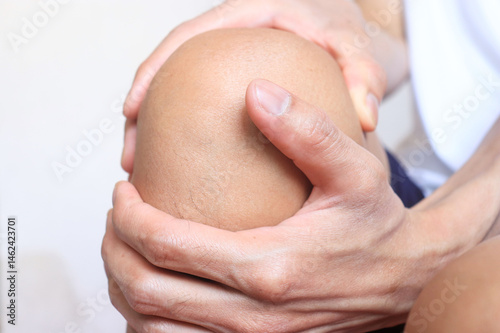 close up of a woman holding a foot