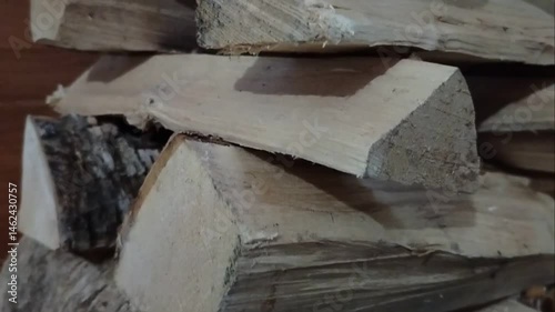 Neatly stacked dry birch firewood for kindling the stove and fireplace, for warmth in the house