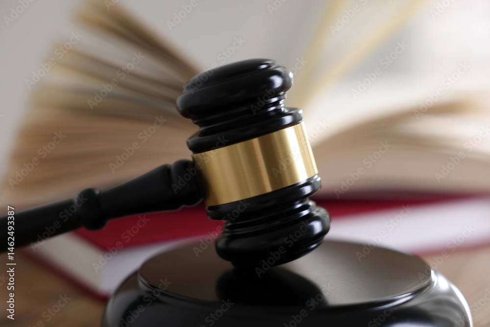 Judge's gavel and books on wooden table indoors, selective focus Judge's gavel and books on wooden table indoors, selective focus