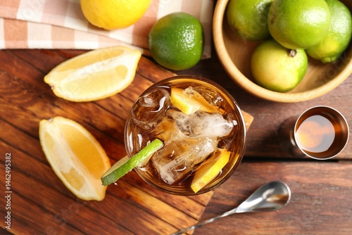 Photography Refreshing Cuba libre cocktail and ingredients on wooden table, flat lay