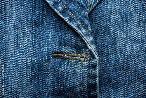 Obraz na płótnie Close-up of a buttonhole on blue denim jacket, showing stitching and seam detail w salonie