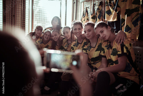 Girls soccer team getting ready in locker room before game