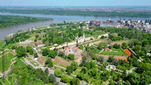 Aerial view of Belgrade where the Sava and Danube rivers meet. Visible landmarks include Kalemegdan Fortress (Beogradska tvrđava), city bridges, and Ušće Park — a perfect urban-meets-nature panorama