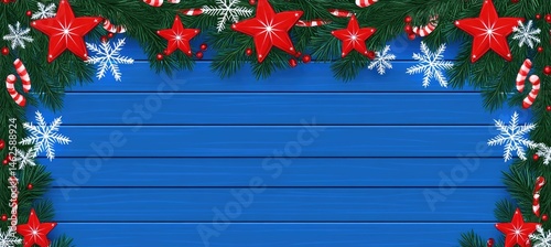 Christmas border with red stars, candy canes, and snowflakes on a blue wooden background