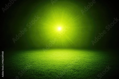 Bright lime green light on a grassy field.  Deep green darkness surrounds a central lime green light, shining on a grassy field
