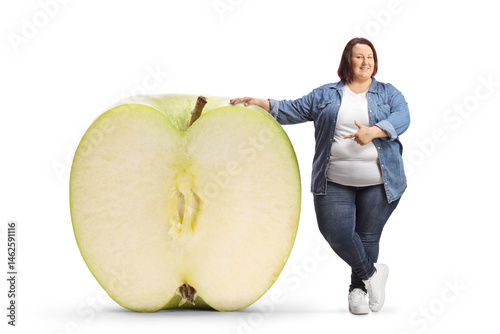 Overweight woman pointing at a big green apple