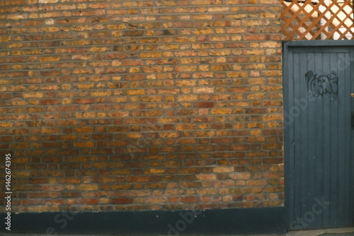 A highly detailed photo of a red brick wall with artistic lighting. weather: . mood: moody and dramatic.