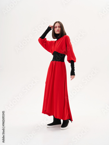 Portrait of a girl model in stylish clothes, in the studio on a light background.
